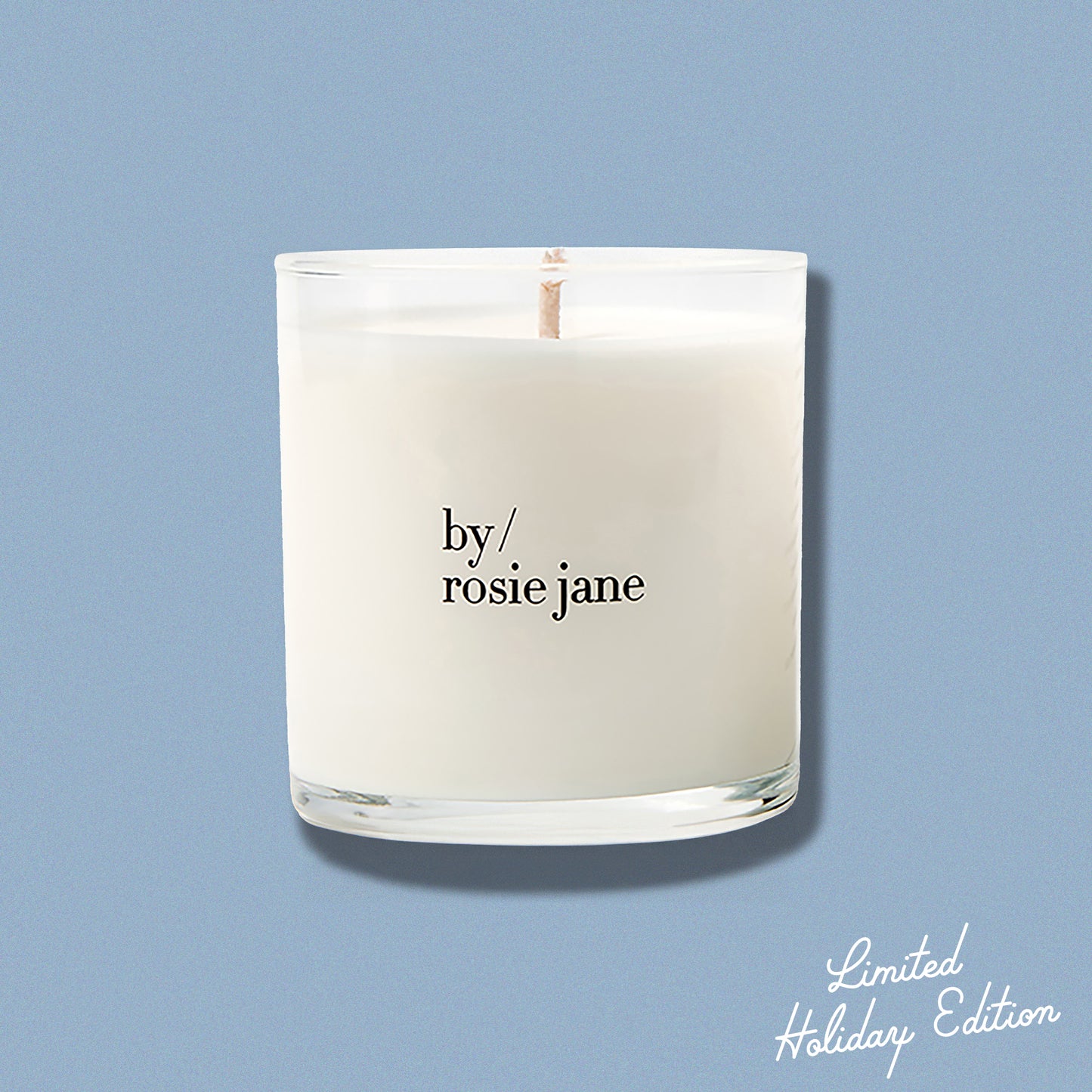 Candle with 'by rosie jane' text on a light blue background