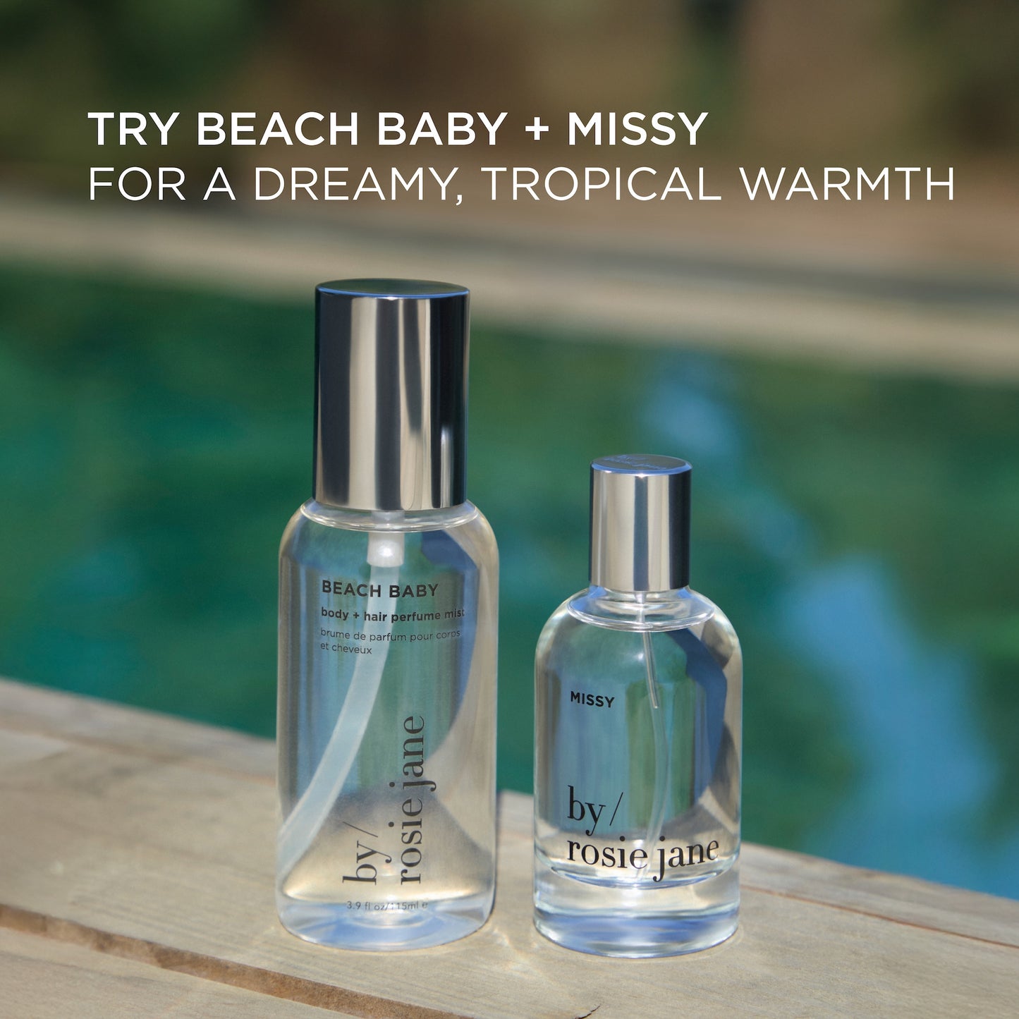 A BEACH BABY BODY + HAIR MIST by byrosiejane sits on a wooden surface near a pool, evoking dreamy, tropical warmth inspired by coconut perfume and beach body mist.