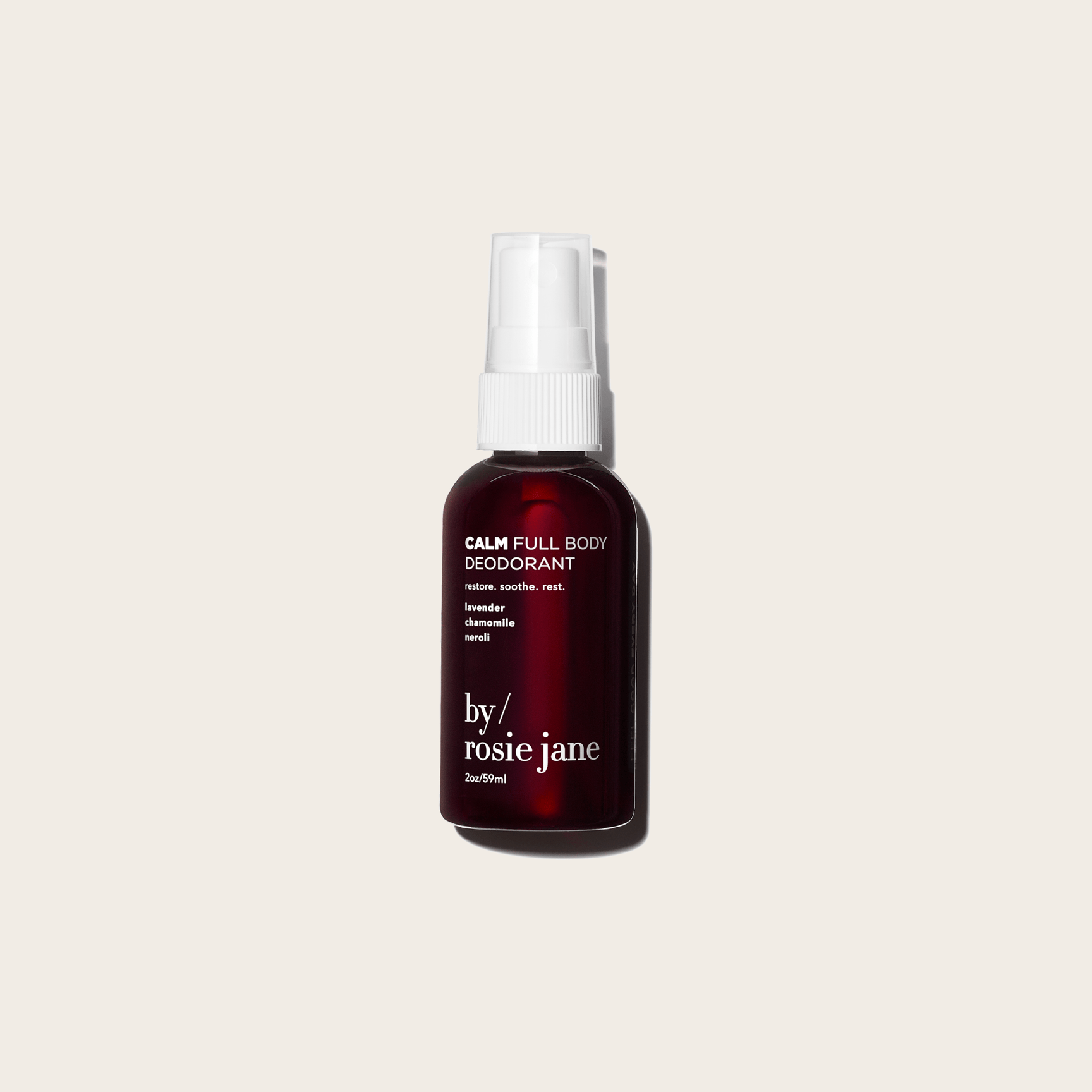 A dark bottle of byrosiejane CALM FULL BODY DEODORANT with a white spray cap, highlighting lavender, chamomile, and neroli scents. This aluminum-free formula is ideal for sensitive skin and shown on a light beige background.