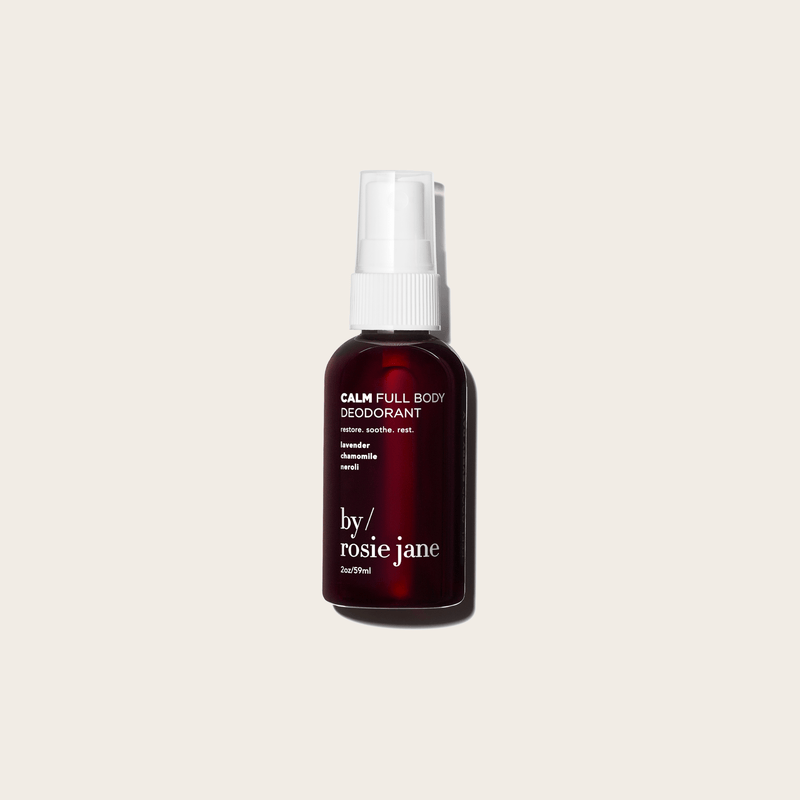 A dark bottle of byrosiejane CALM FULL BODY DEODORANT with a white spray cap, highlighting lavender, chamomile, and neroli scents. This aluminum-free formula is ideal for sensitive skin and shown on a light beige background.