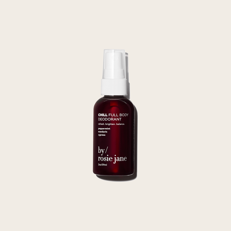 A dark amber spray bottle labeled CHILL FULL BODY DEODORANT by byrosiejane—aluminum-free and ideal for sensitive skin—stands against a beige background, featuring minimalist design and a white spray cap.