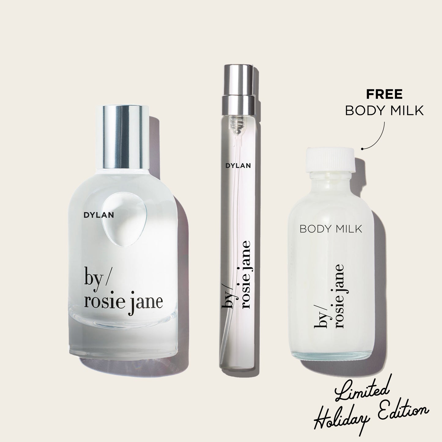 Three bottles of 'by rosie jane' and 'Dylan' on a light beige background with text indicating free body milk and limited holiday edition.