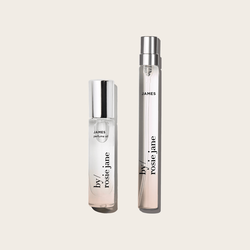 The byrosiejane JAMES 2 WAYS TRAVEL SET features two clear glass bottles—a Perfume Oil with a white cap and a Travel Spray Eau de Parfum with a silver cap—displayed on a light beige background.