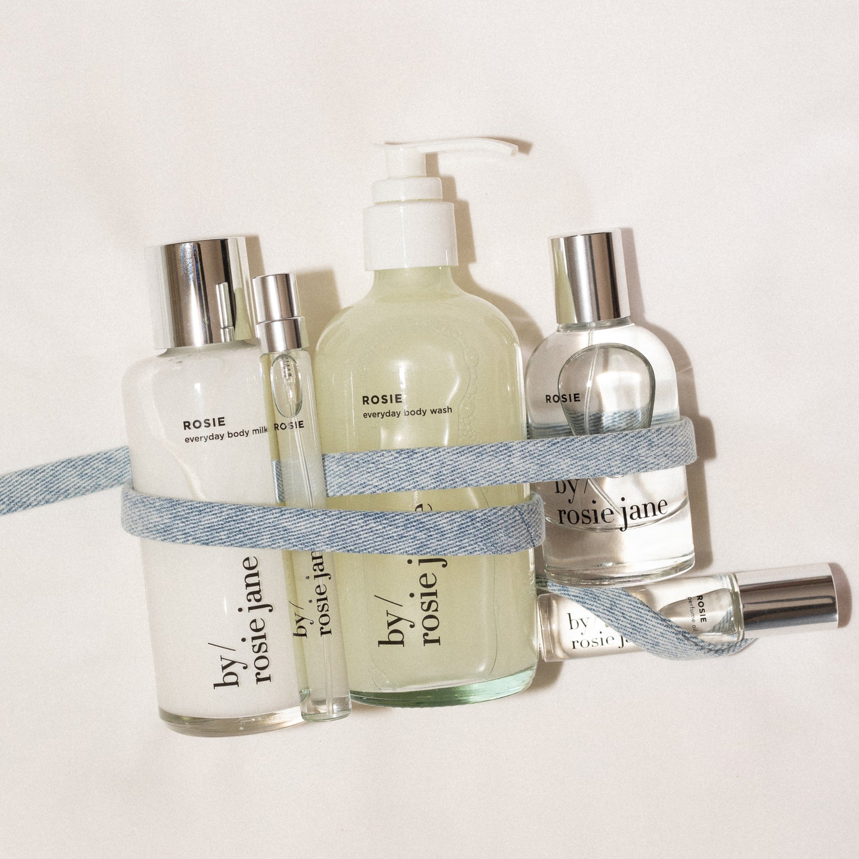 Collection of Rosie 'by rosie jane' skincare products on a light background with ribbon
