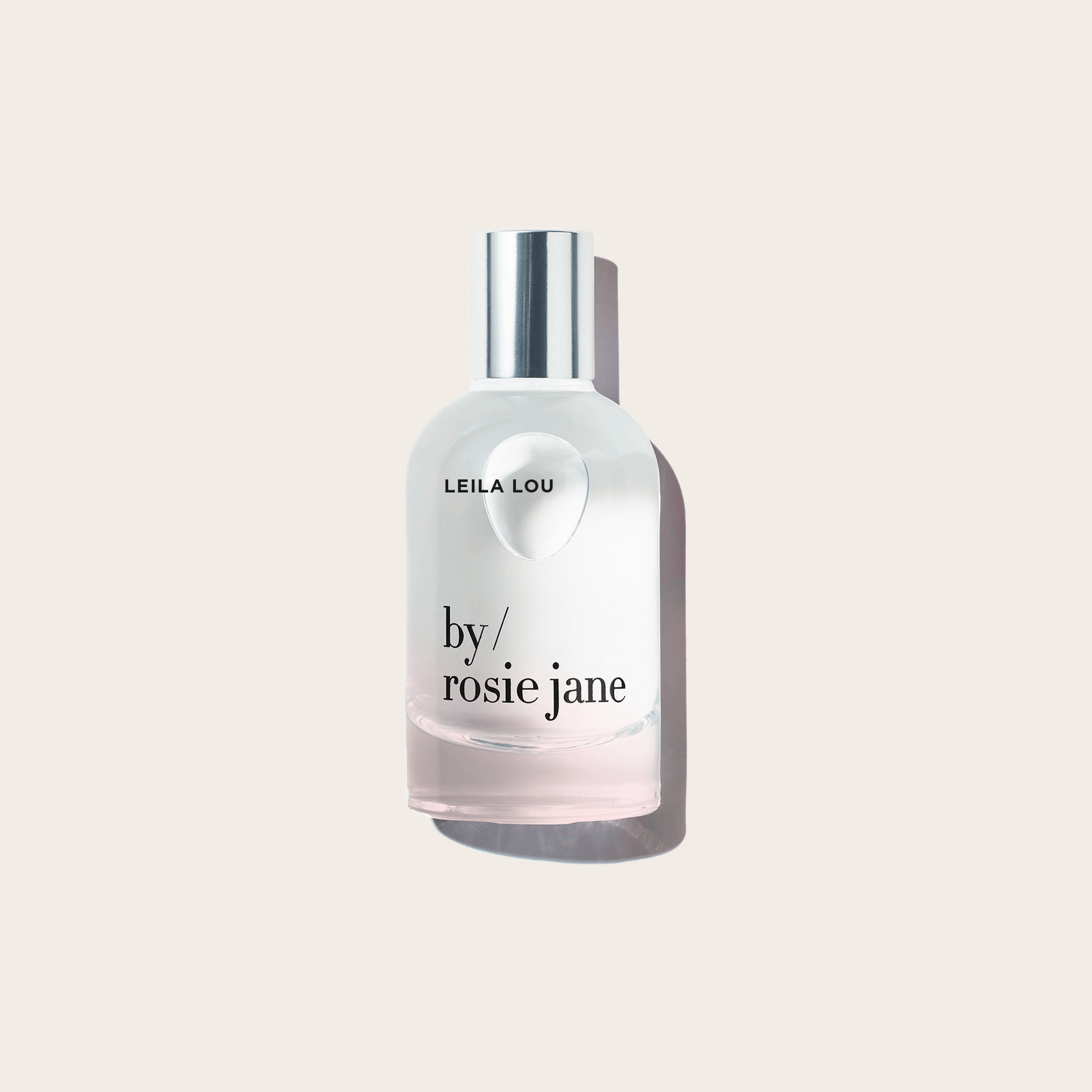 The LEILA LOU PERFUME by byrosiejane is shown in a clear glass bottle with a silver cap against a light beige background—an ideal spring and everyday scent, featuring delicate jasmine notes.