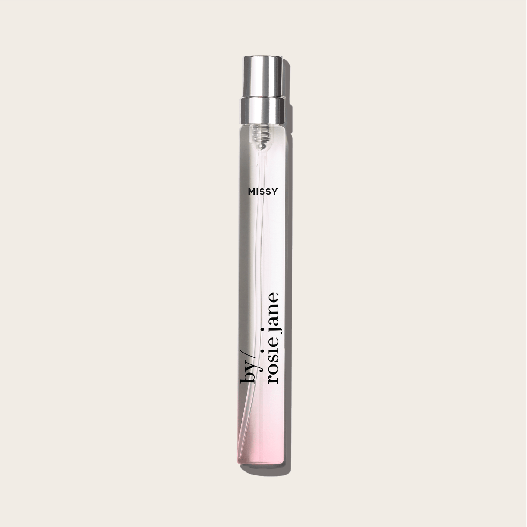 A slim, clear glass MISSY TRAVEL SPRAY bottle by byrosiejane, filled with light pink liquid inspired by green mandarin notes, is shown against an off-white background.