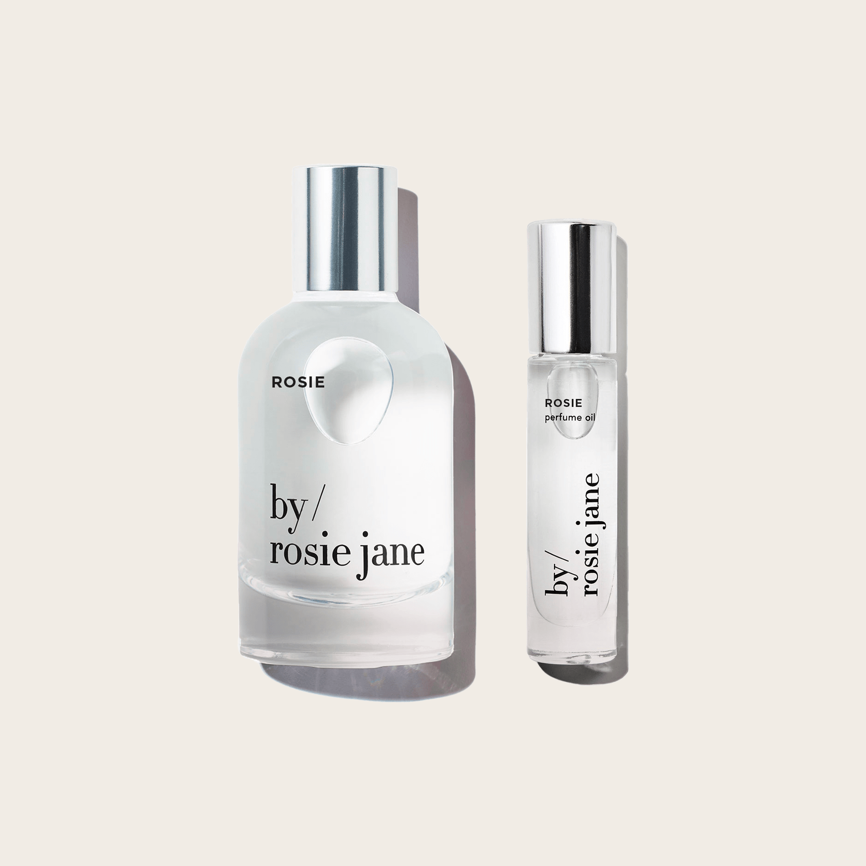 The byrosiejane ROSIE LAST ALL DAY SET features two clear perfume bottles, one large and one small, with silver caps—both offering long-lasting fragrance for all-day freshness.