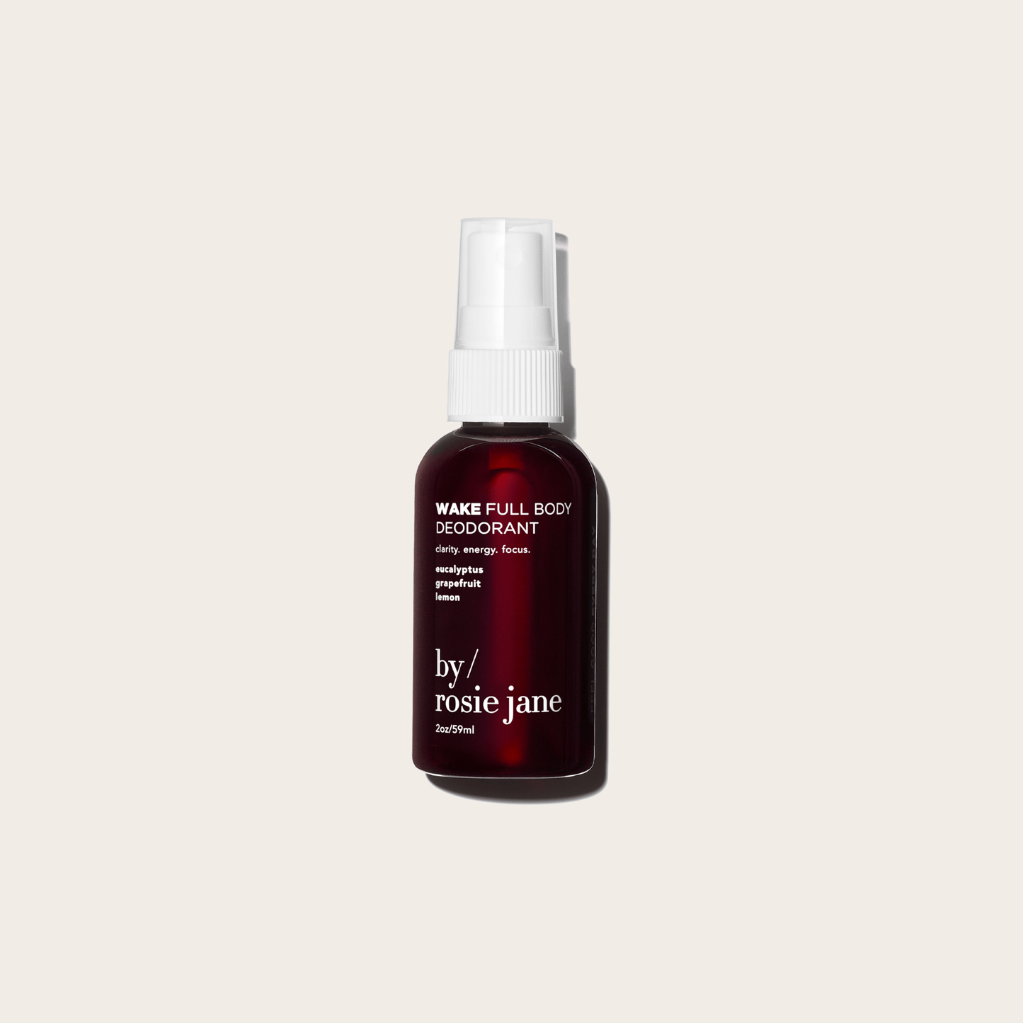 A dark amber spray bottle of WAKE FULL BODY DEODORANT by byrosiejane, ideal for sensitive skin and featuring grapefruit, lemon, and sweet orange notes, is centered on a plain light beige background.