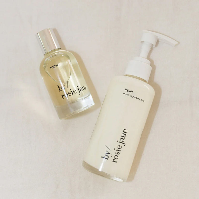 Two REMI skincare products from 'by Rosie Jane' on a light background