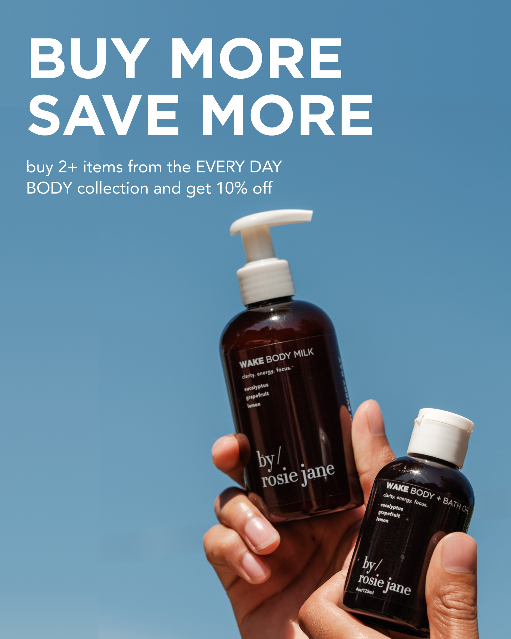 Two hands holding bottles of by/rosie jane Wake Body Milk and Wake Body + Bath Oil against a clear blue sky, with text promoting 10% off when buying 2 or more items from the EVERY DAY BODY collection.