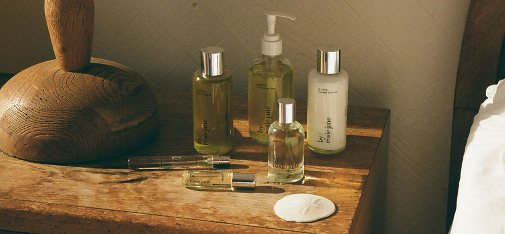 Set of skincare products on a wooden surface with a neutral background