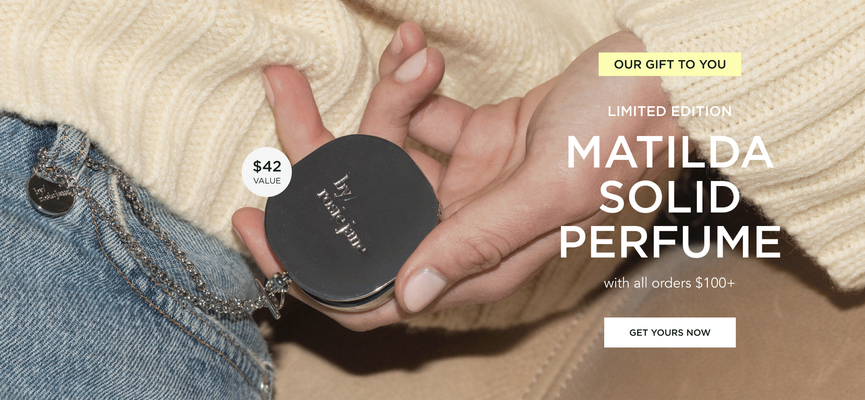 a woman holiding the free matilda solid perfume 