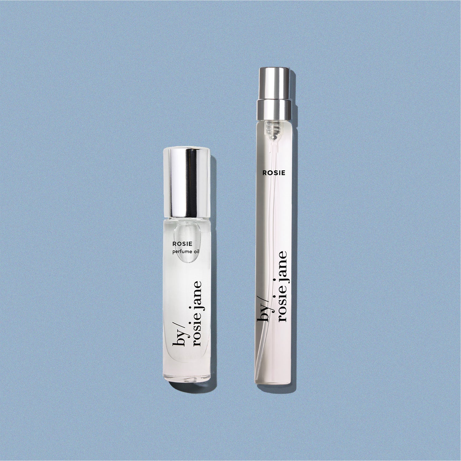 perfume oil and travel spray on blue background