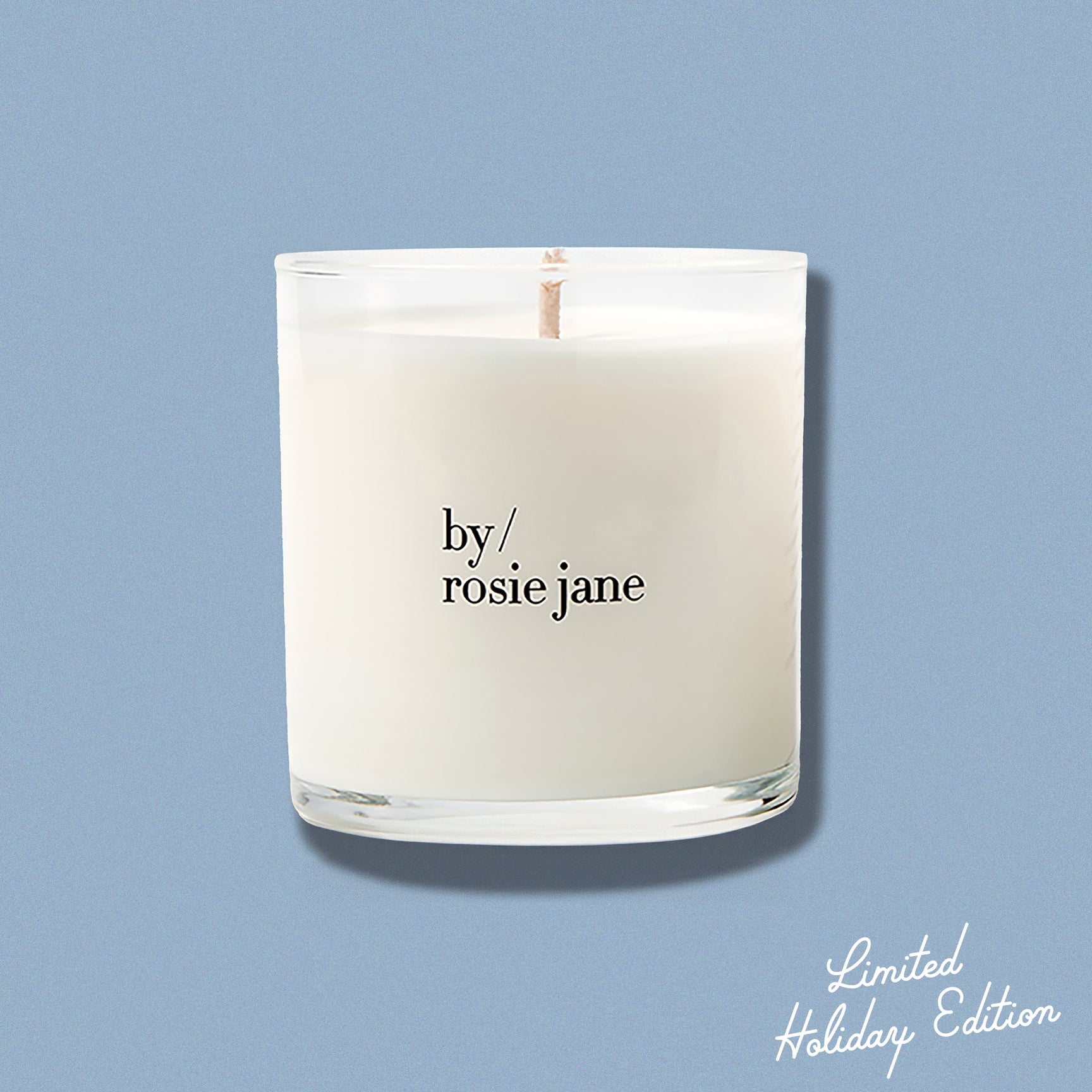 Candle with 'by rosie jane' text on a light blue background