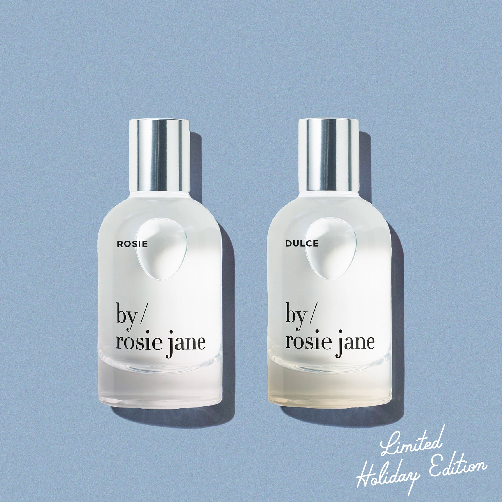 Rosie and Dulce 'by Rosie Jane' perfume bottles on a light blue background 