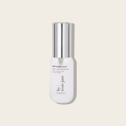 mini bottle labeled 'Birthday Suit' by Rosie Jane on a light beige background