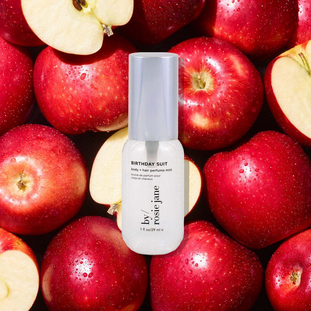 mini bottle with 'Birthday Suit' text on a background of red apples