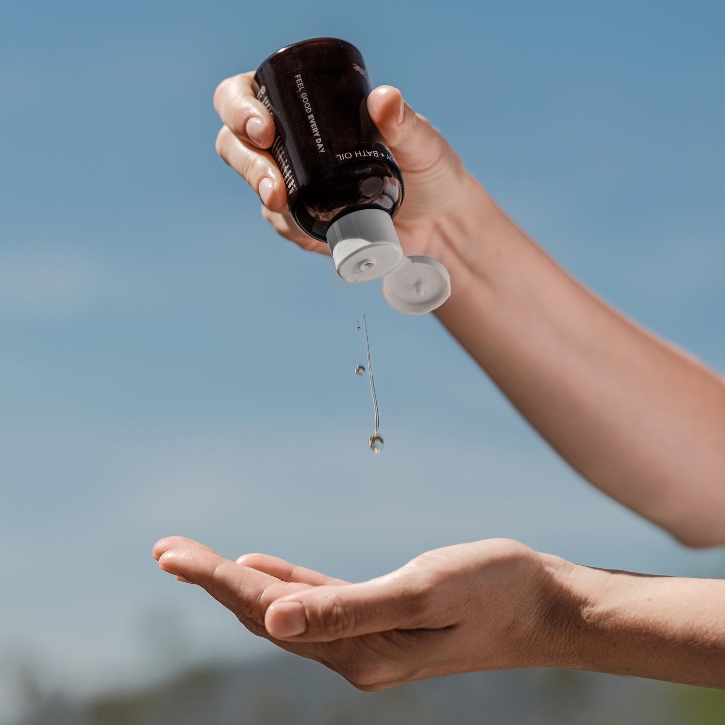 calm body oil in hand