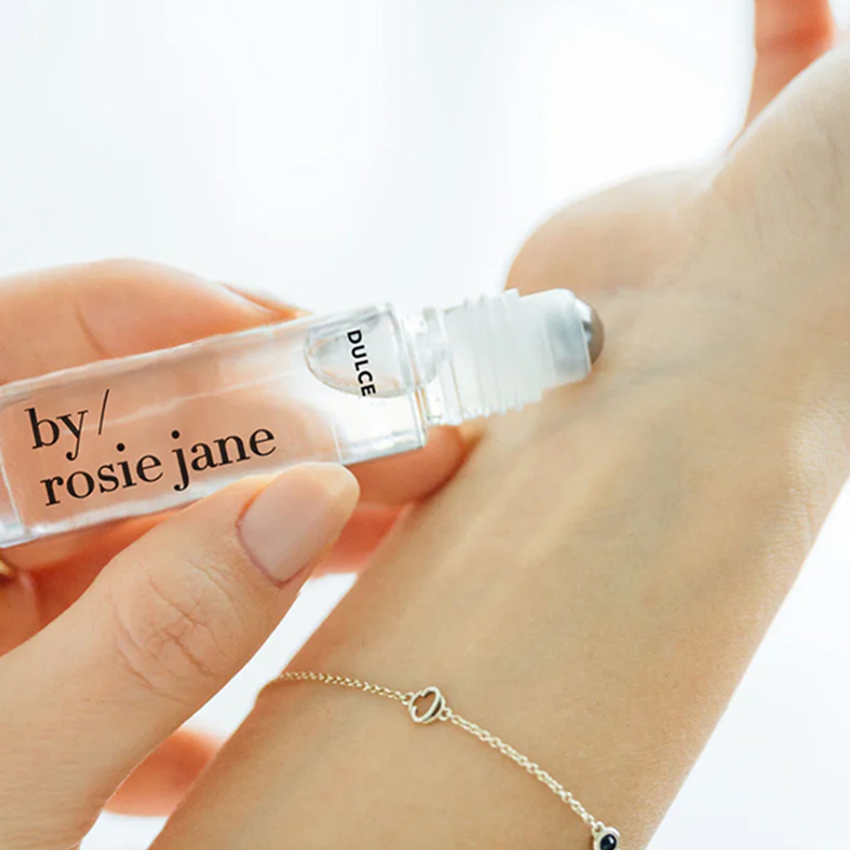 rolling dulce perfume oil onto wrist