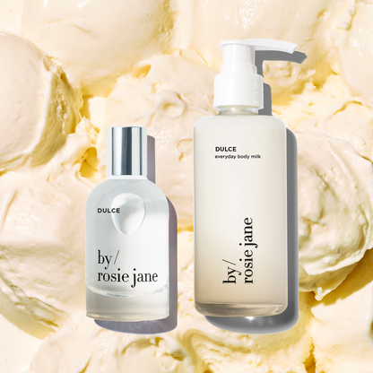 Two bottles of 'by rosie jane' DULCE skincare products on a background of vanilla ice cream scoops