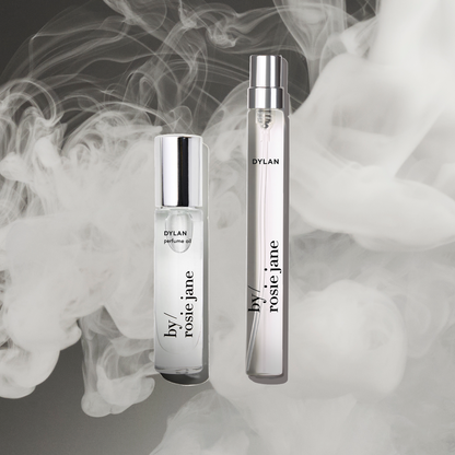 Two perfume bottles labeled 'Dylan' and 'By Rosie Jane' with smoke effect in the background.