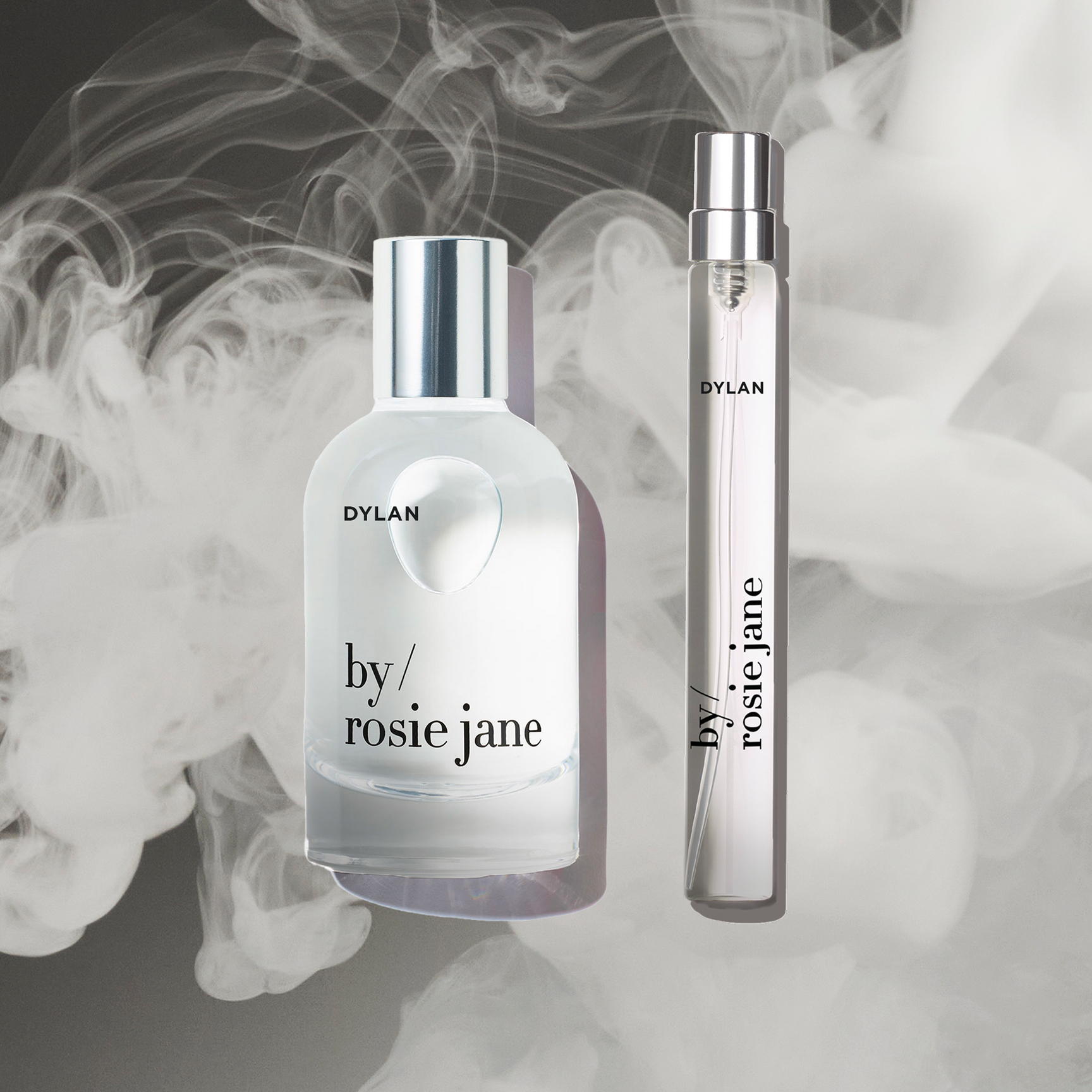 The DYLAN HOME + AWAY SET by byrosiejane features a glass perfume bottle and travel spray displayed against a smoky background, making it the perfect limited edition Mothers Day gift.