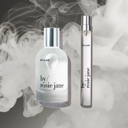 Two perfume bottles labeled 'by rosie jane' with smoke effect in the background