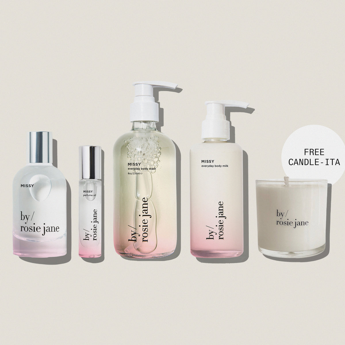 Five By Rosie Jane skincare and body care products arranged on a muted blue-gray background, including a large pump bottle, a small roller bottle, a tall body milk bottle, and a candle jar with a 'FREE CANDLE - ITA' callout. The products are mostly frosted white with clear sections and silver caps.