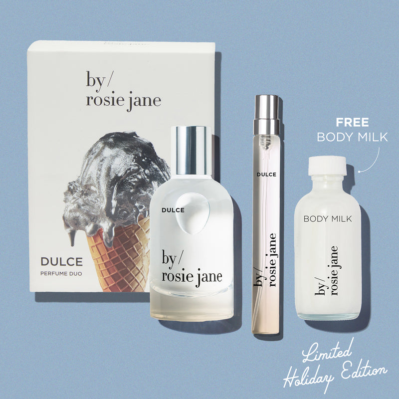 By Rosie Jane DULCE perfume set with packaging and bottles on a blue background