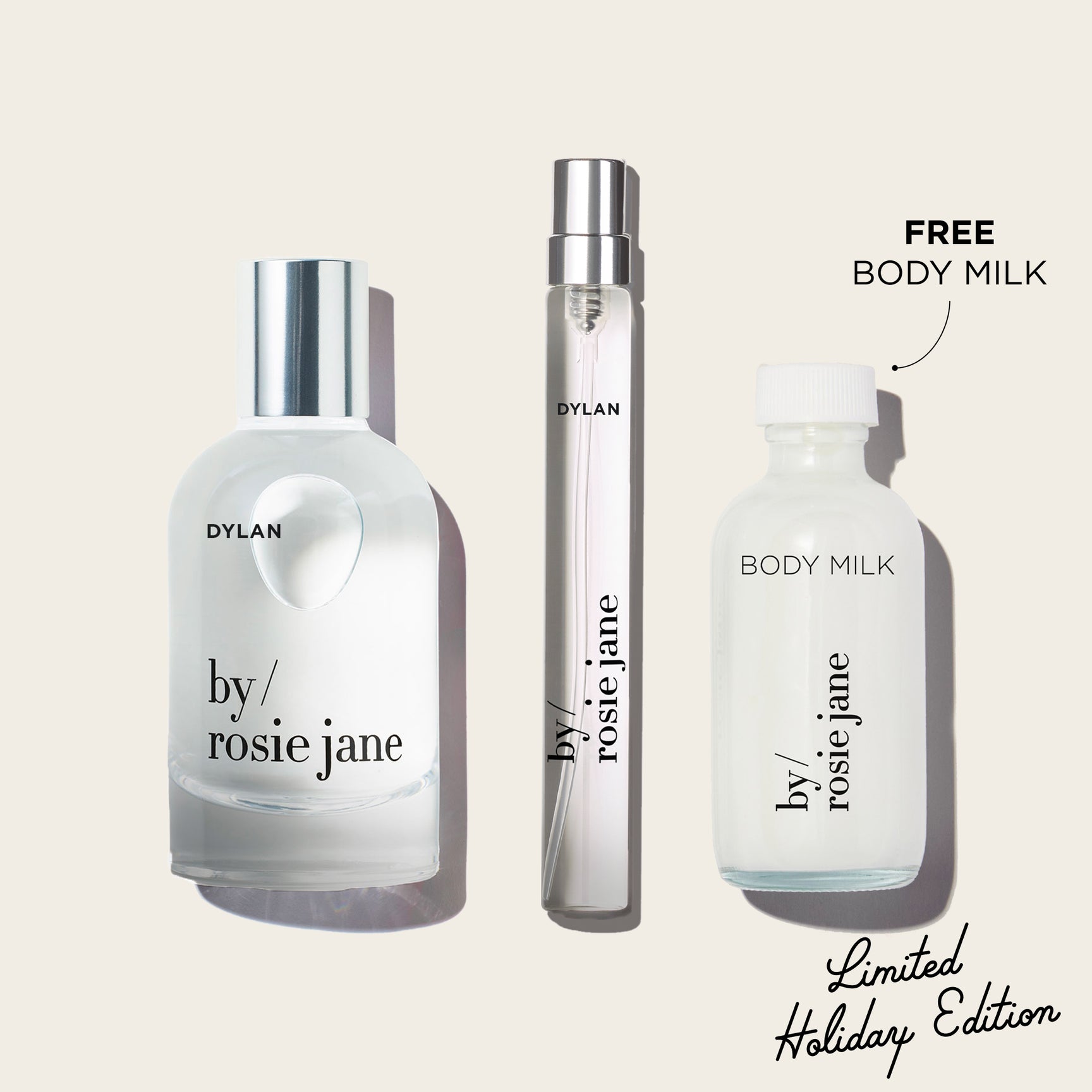 Three bottles of 'by rosie jane' and 'Dylan' on a light beige background with text indicating free body milk and limited holiday edition.