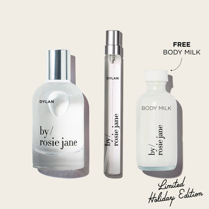 Three bottles of 'by rosie jane' and 'Dylan' on a light beige background with text indicating free body milk and limited holiday edition.