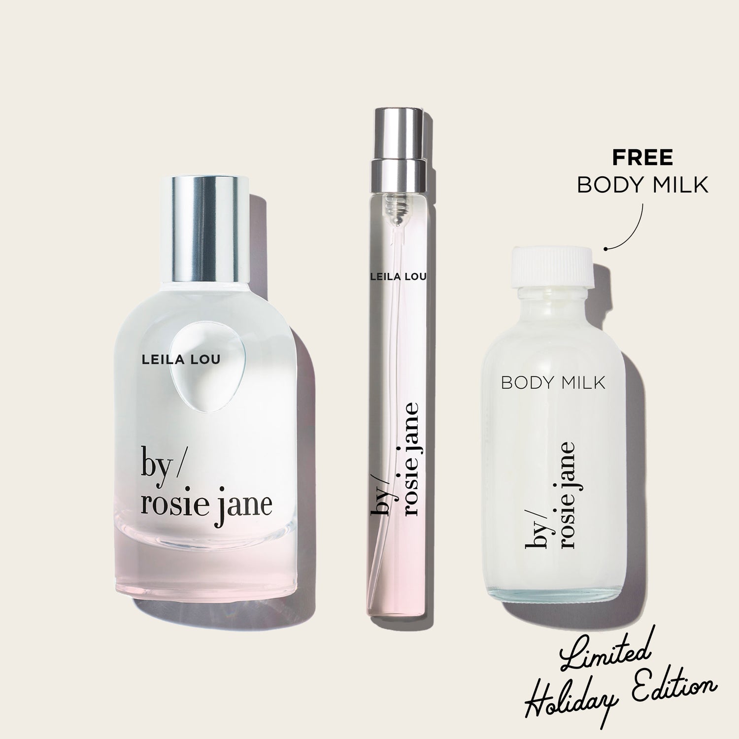 Three  LEILA LOU bottles of 'by Rosie Jane' perfume and body milk on a light beige background