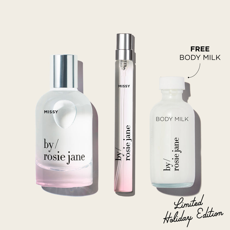 Three MISSY 'by Rosie Jane' perfume bottles on a white background with 'Free Body Milk' text.