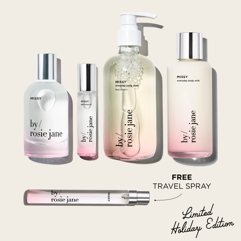 Collection of 'by rosie jane' beauty products on a light beige background