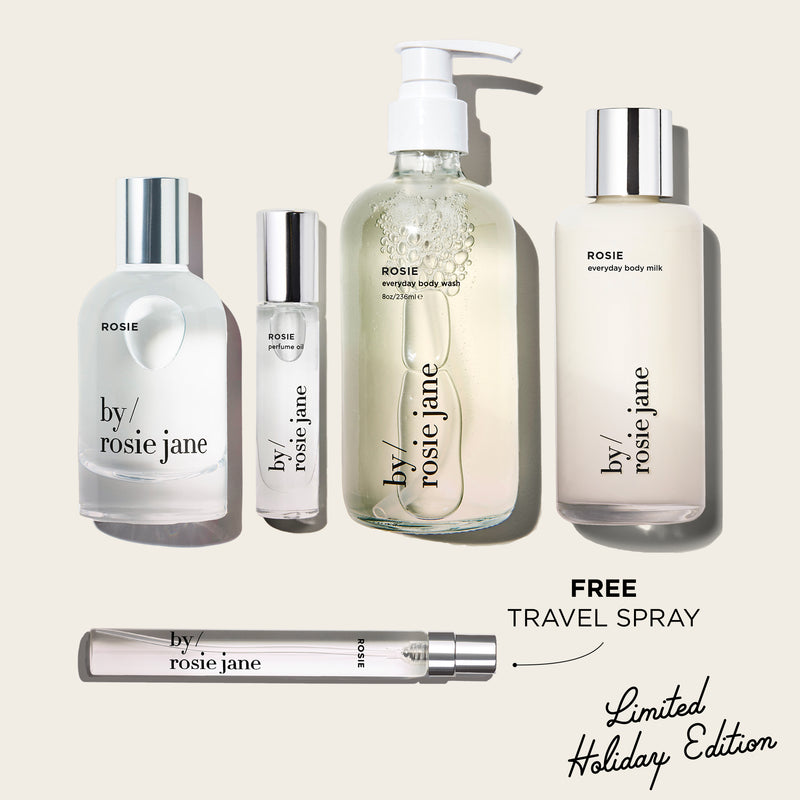 Collection of Rosie 'by rosie jane' skincare products on a beige background