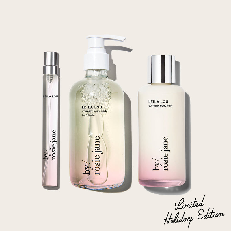 three LEILA LOU products, body wash, body milk, and a travel spray by 'by rosie jane' on a light beige background with 'Limited Holiday Edition' text.