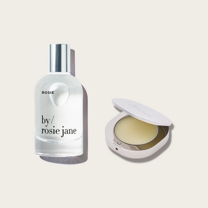 Bottle and solid perfume of 'by Rosie Jane' on a light beige background