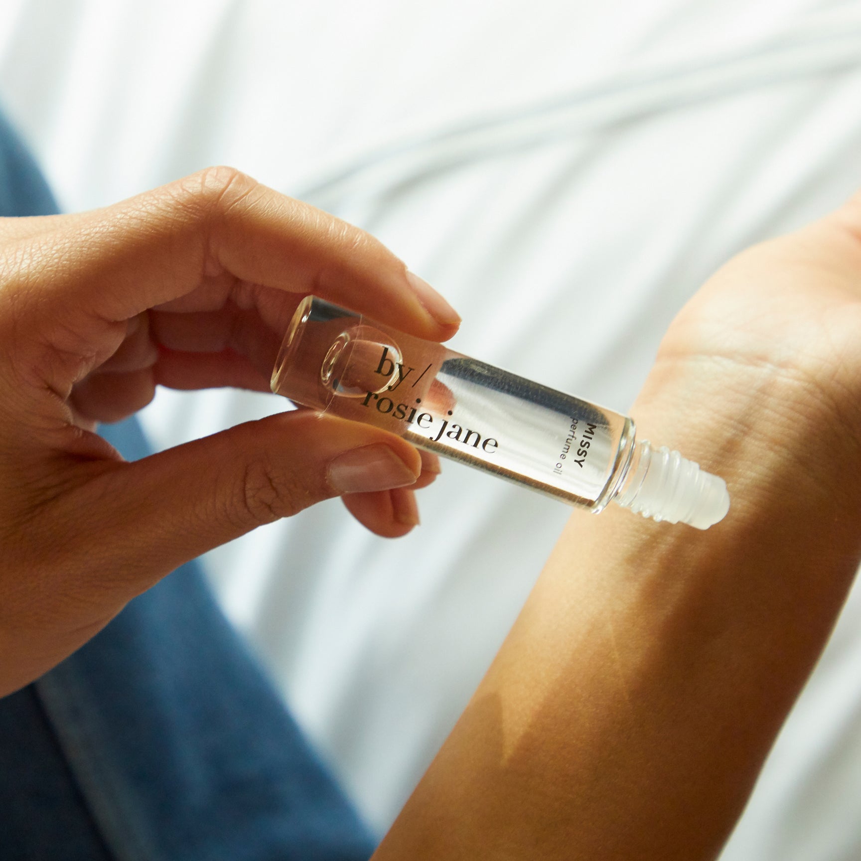 missy perfume oil being rolled on skin
