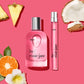 Missy Home + Away Set featuring two perfume bottles, one full-size and one travel-size, surrounded by tropical fruits like pineapple and coconut.