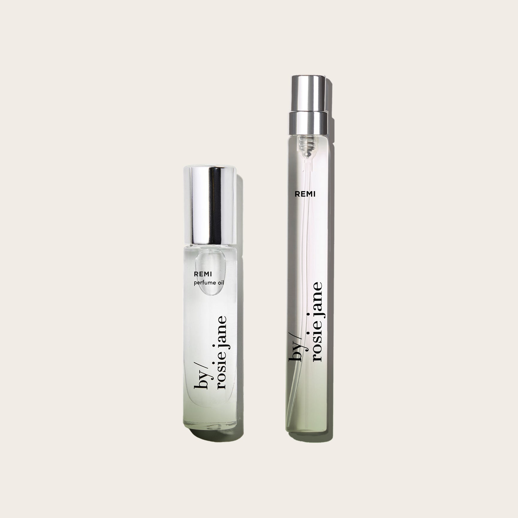 Two perfume bottles labeled 'REMI' and 'by rosie jane' on a light beige background