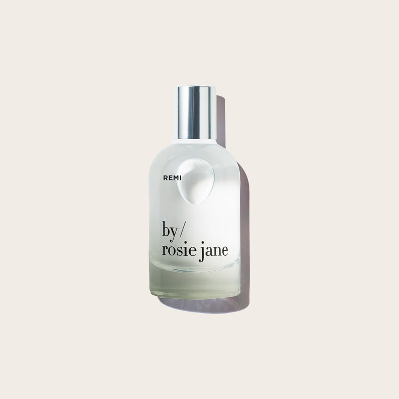 REMI perfume bottle on light background