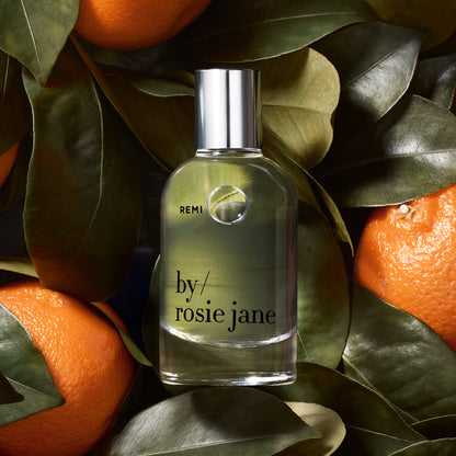 REMI bottle on background of mandarins