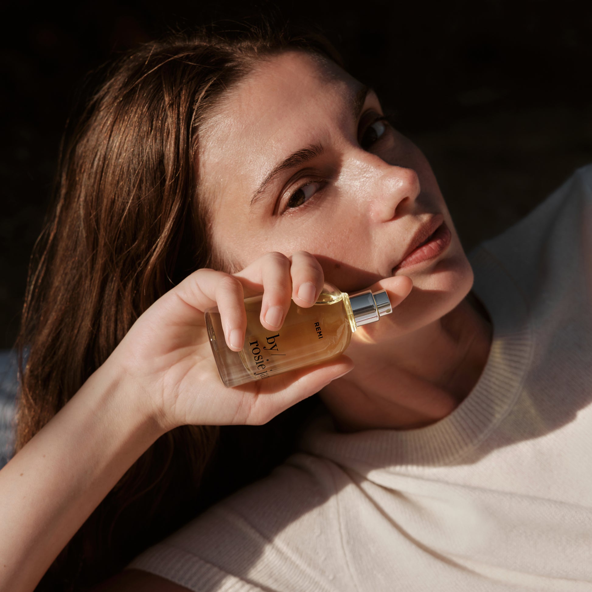 woman holding a REMI bottle