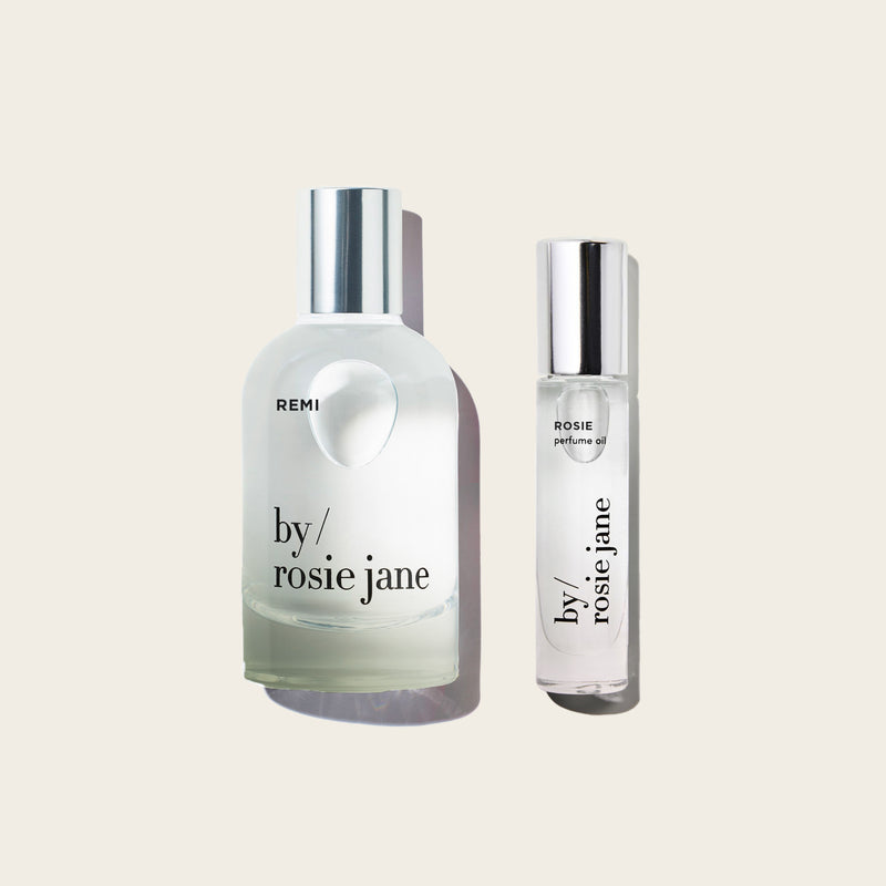 remi edp and rosie perfume oil on tan background
