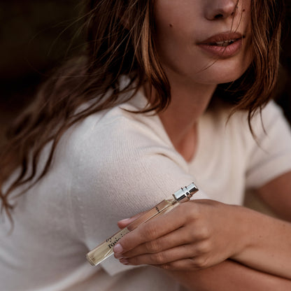 woman holding REMI travel spray