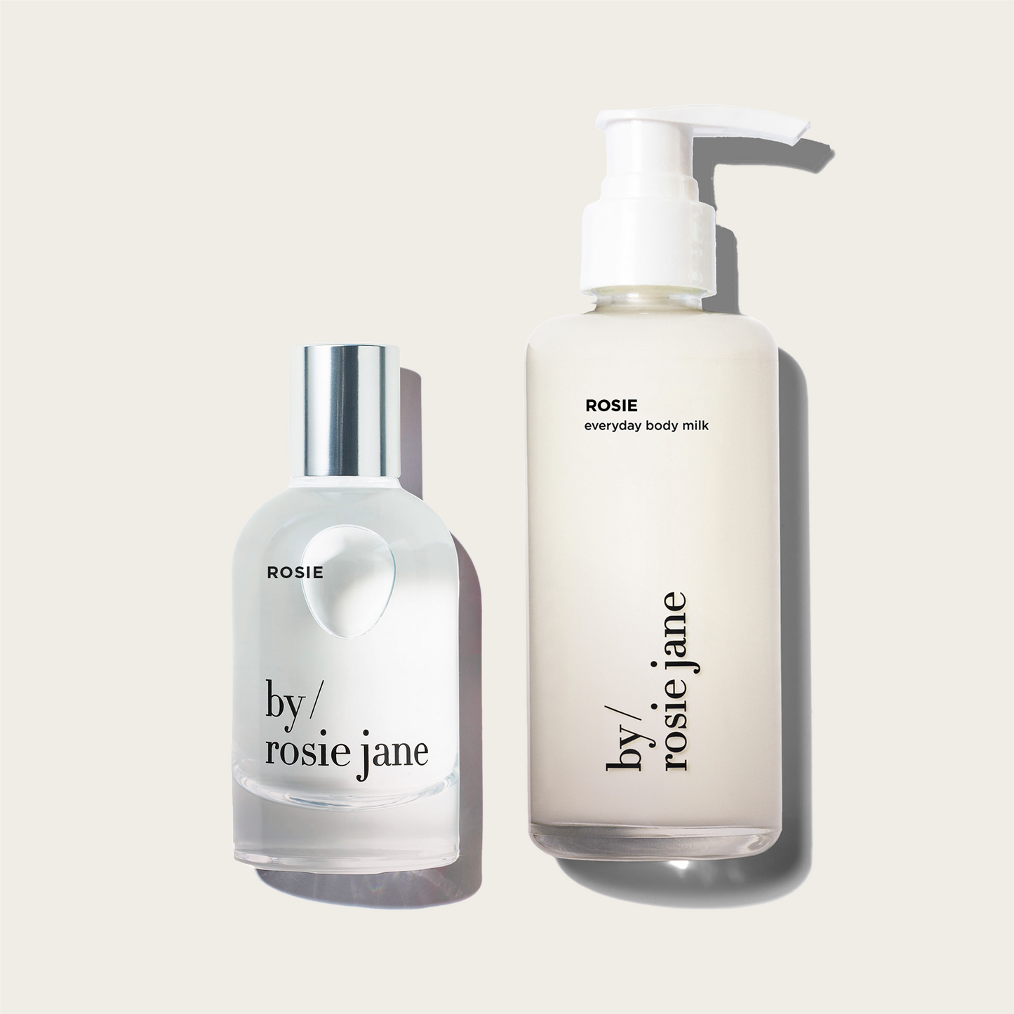 Two bottles of ROSIE 'by Rosie Jane' products on a light beige background