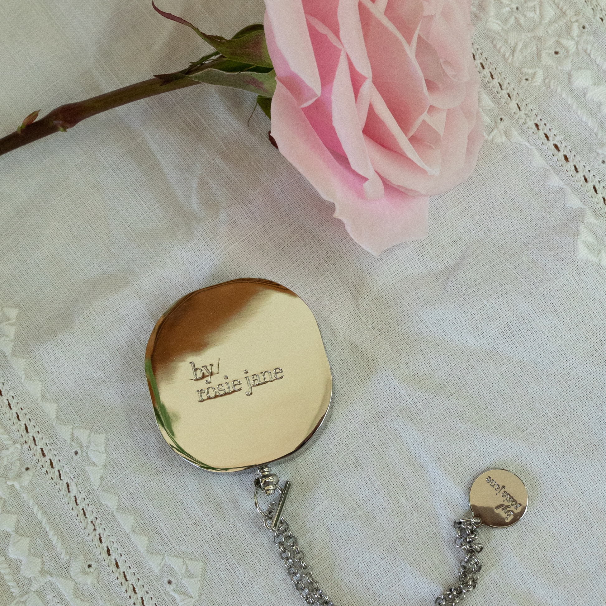 ROSIE SOLID PERFUME on a lace background with a pink rose.