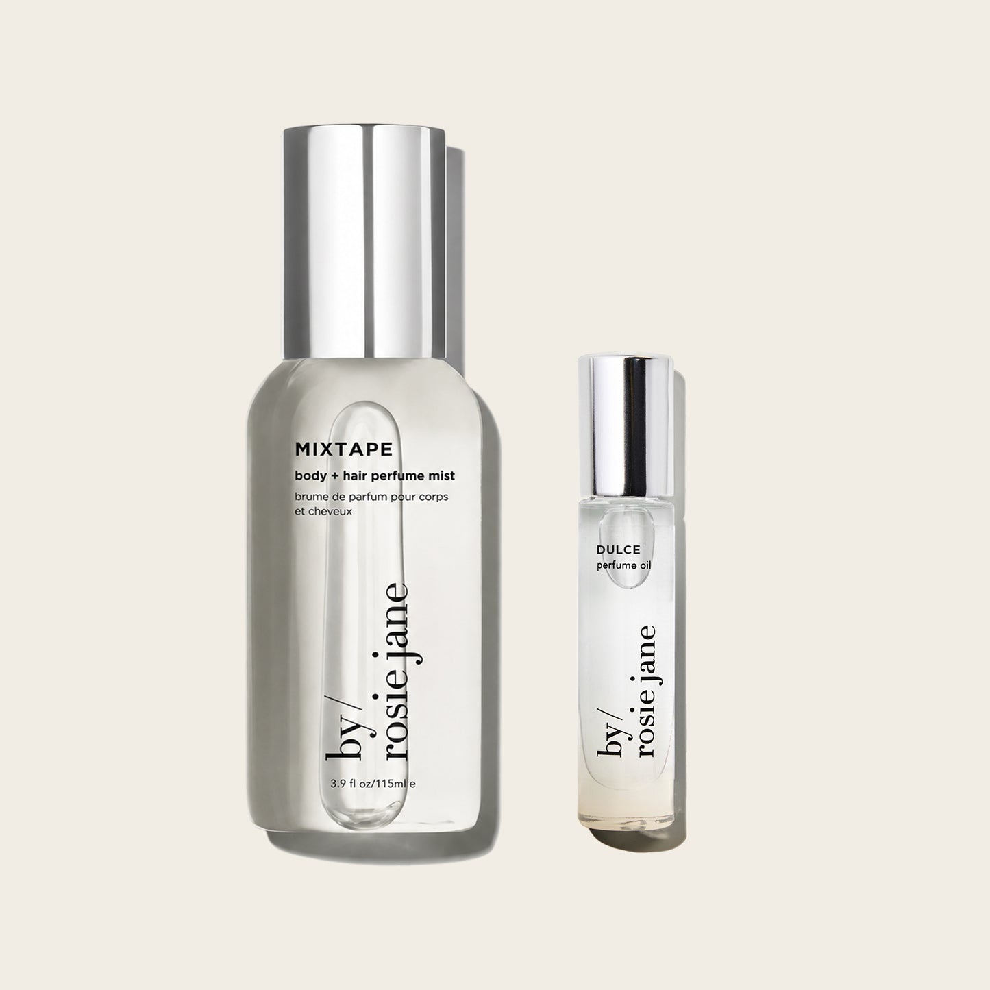 Two clear cosmetic bottles with silver caps on a light warm gray background: a larger bottle labeled MIXTAPE body + hair perfume mist and a smaller bottle labeled DULCE perfume oil, both from by rosie jane.