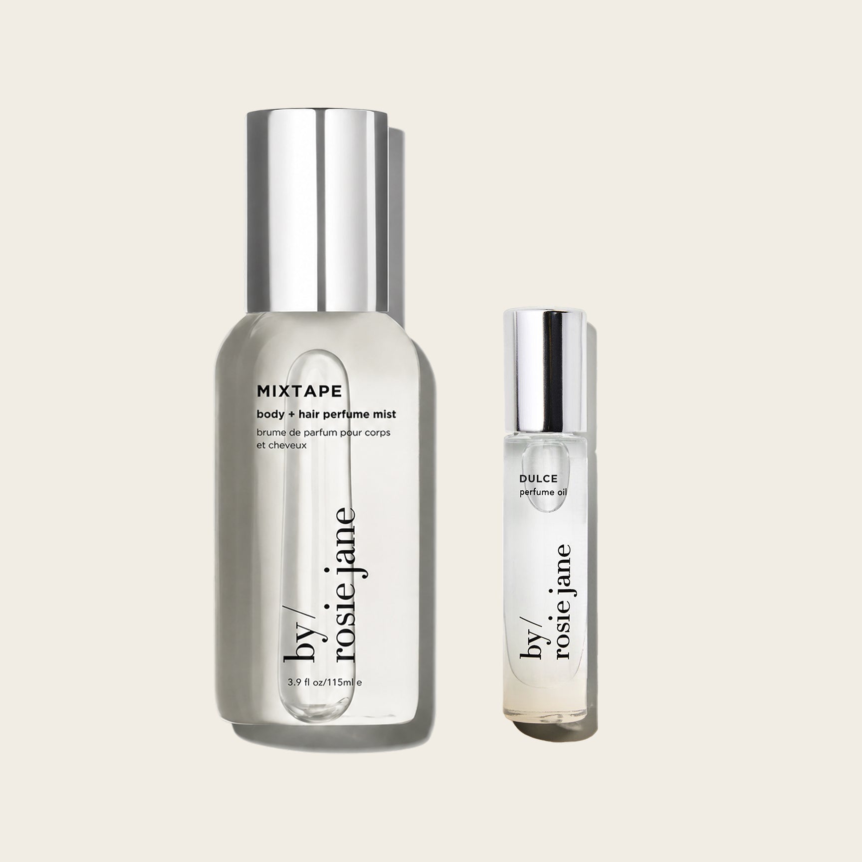 Two clear cosmetic bottles with silver caps on a light warm gray background: a larger bottle labeled MIXTAPE body + hair perfume mist and a smaller bottle labeled DULCE perfume oil, both from by rosie jane.