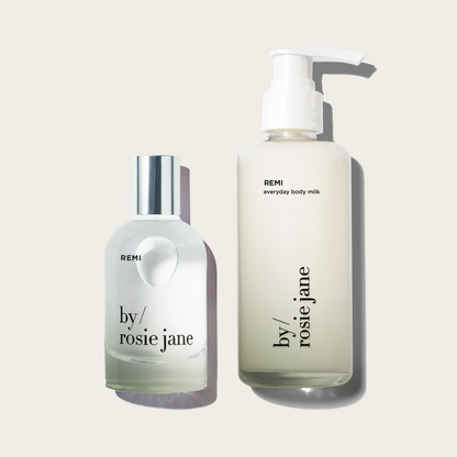 Two bottles of Remi 'by Rosie Jane' products on a light beige background